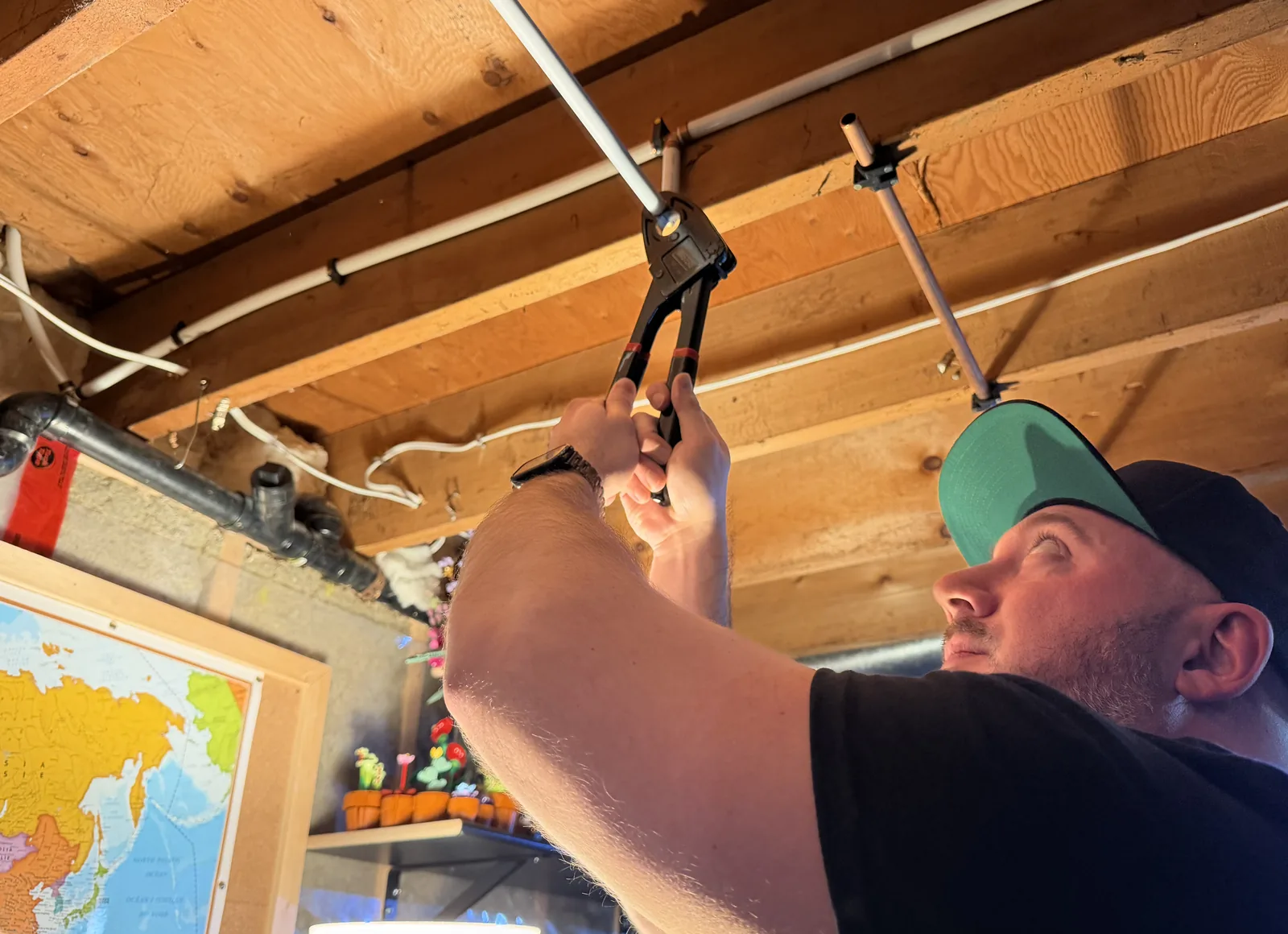 Gentlemen Plumbing plumber repairing a water pipe in a utility area.