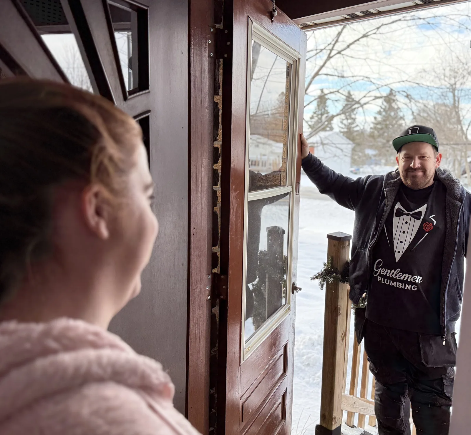 Gentlemen Plumbing technician greeting a homeowner at the front door for an Ottawa service visit.