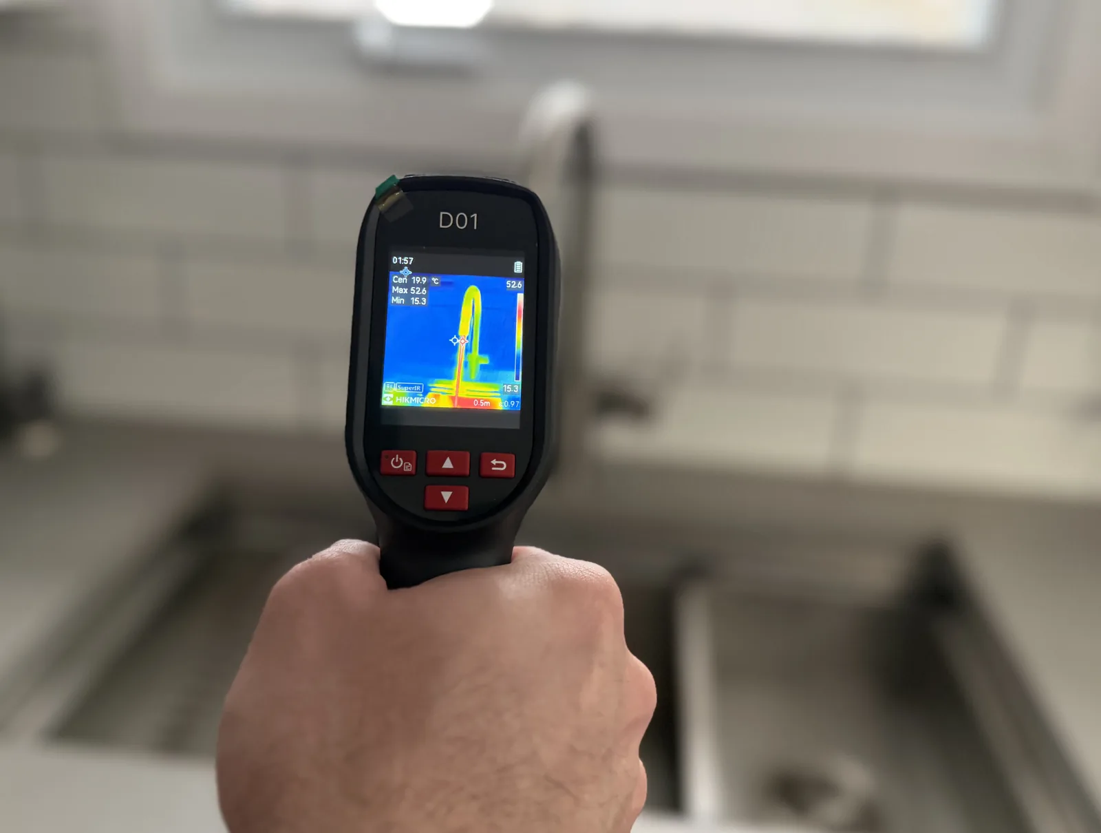Thermal camera used near a kitchen sink during plumbing diagnosis.