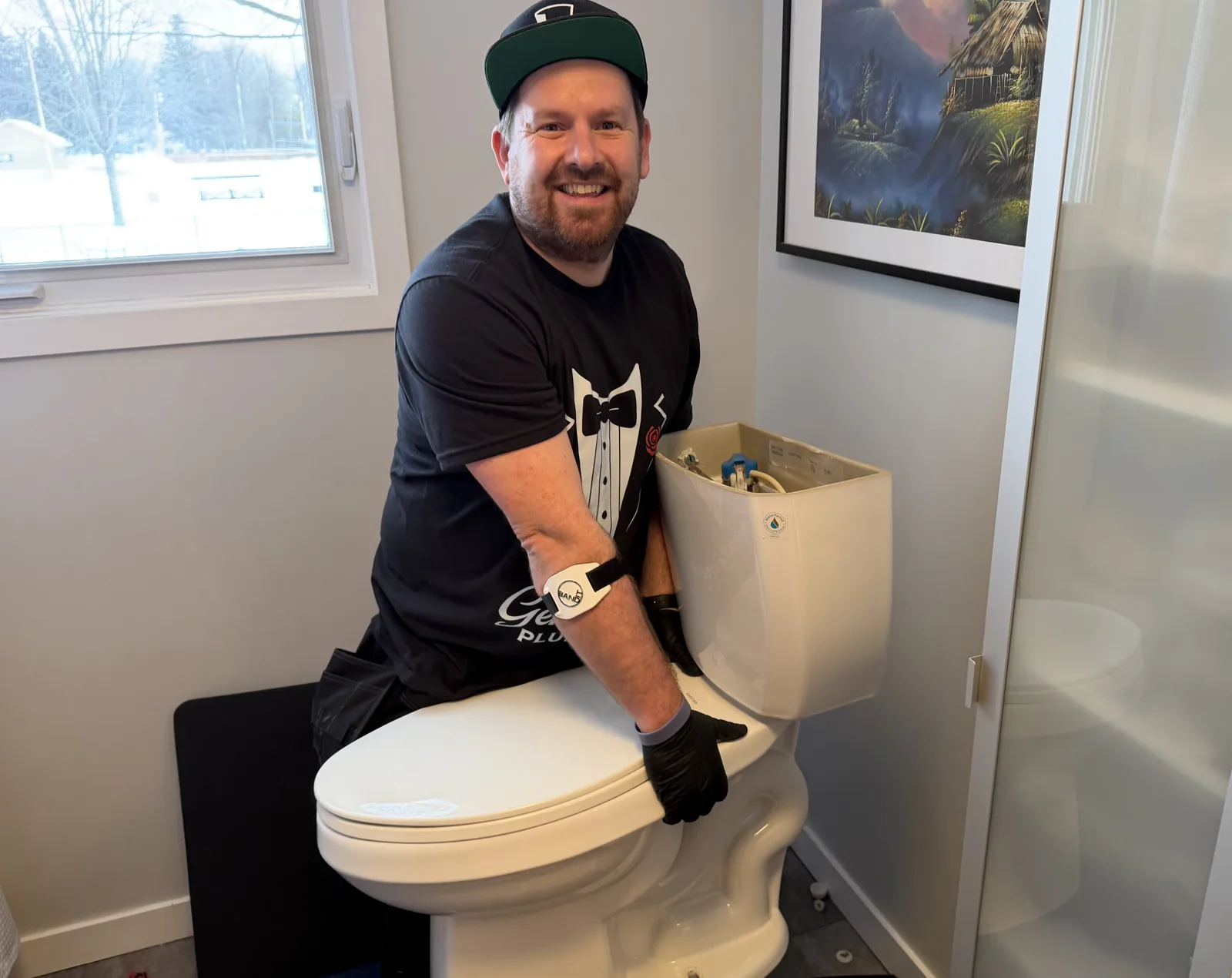 Jonathan setting a toilet base in place during an installation