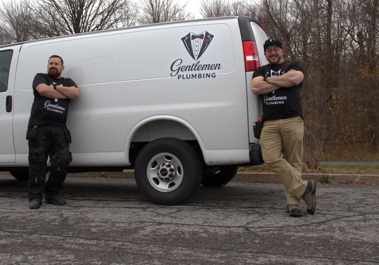 Gentlemen Plumbing team beside service van