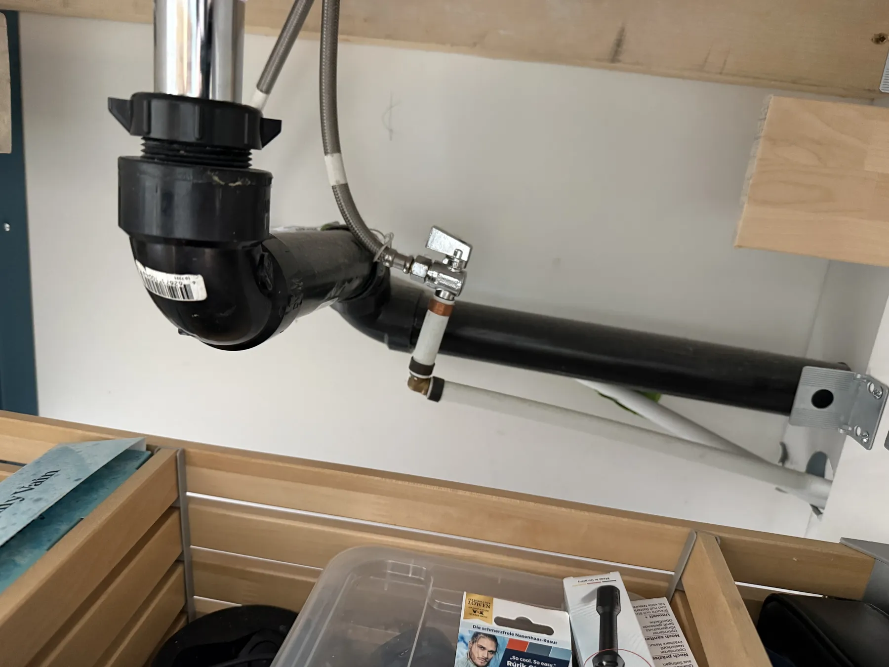 Close-up of plumbing shutoff valve and drain piping in an Ottawa home.