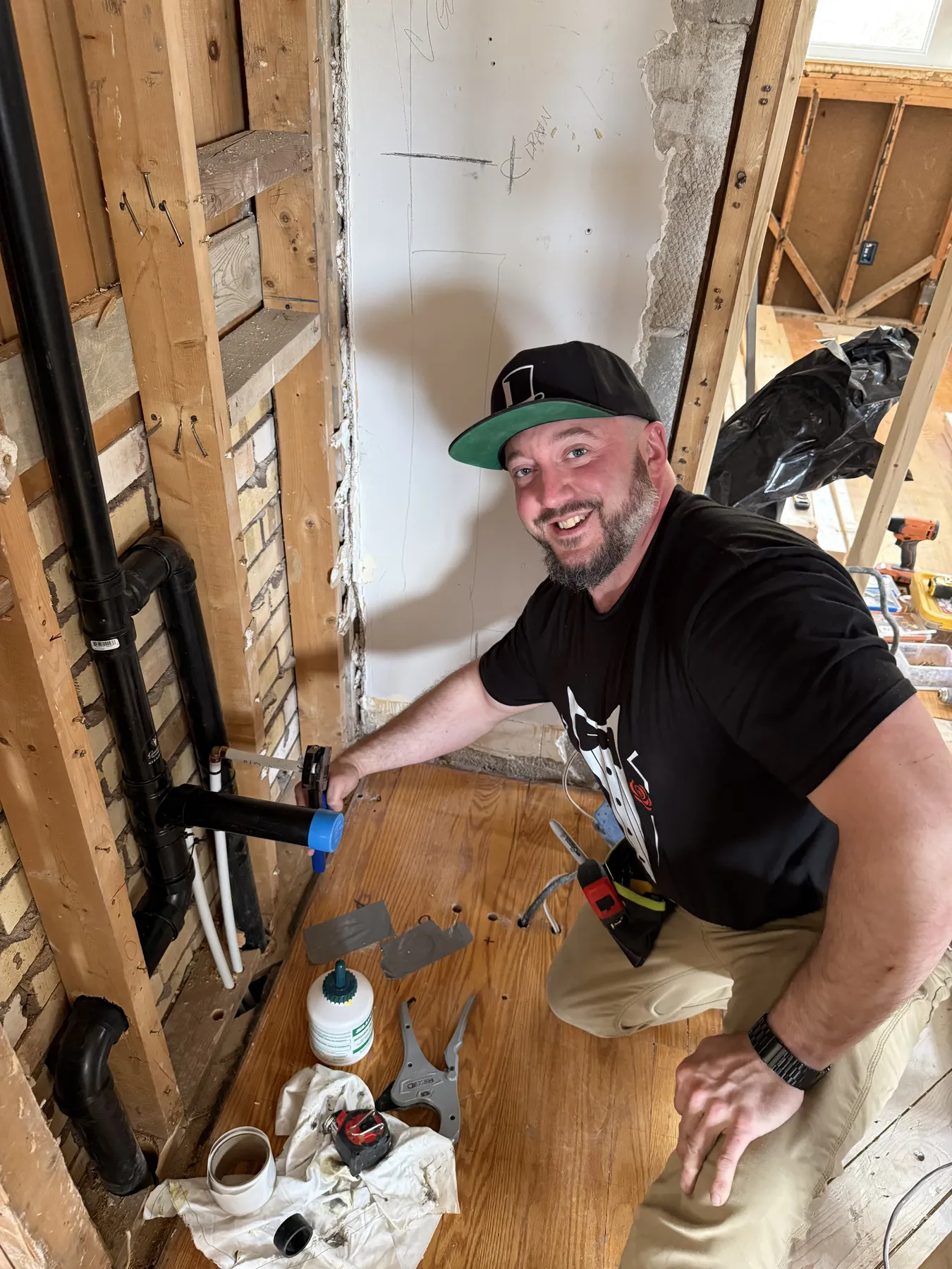 Gentlemen Plumbing technician testing a wall-hung toilet installation.
