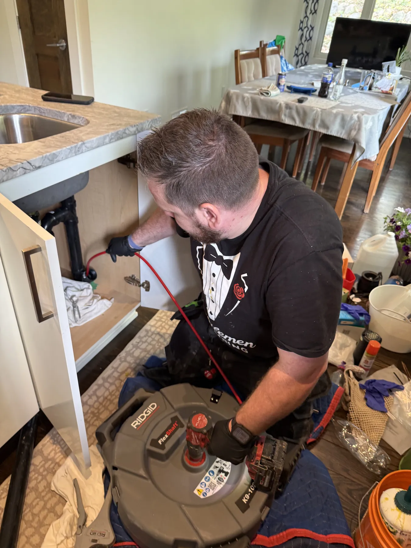 Kitchen drain cleaning equipment under an Ottawa sink