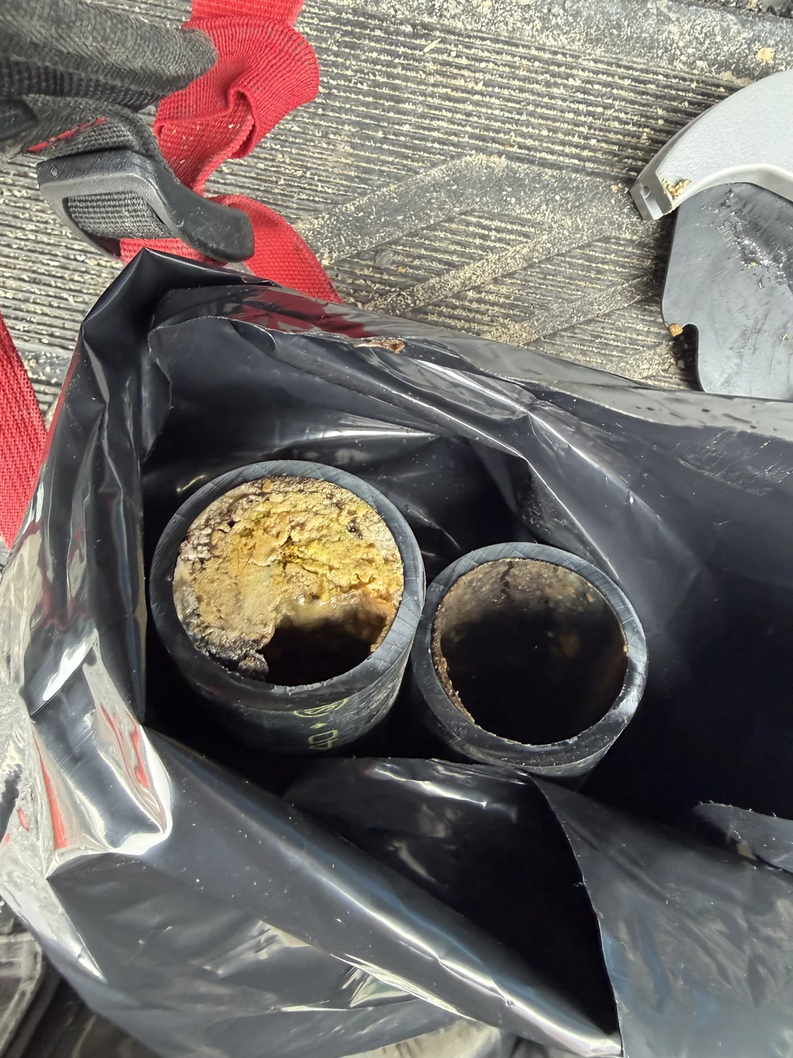 Grease buildup in a kitchen drain line before drain cleaning.
