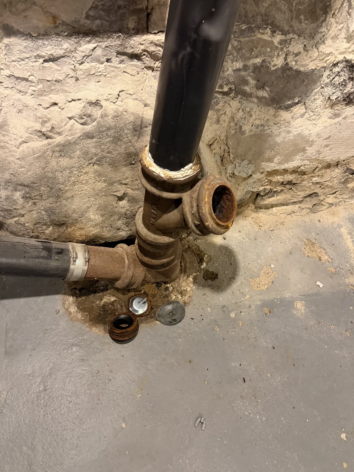 Old cast-iron drain before replacement.
